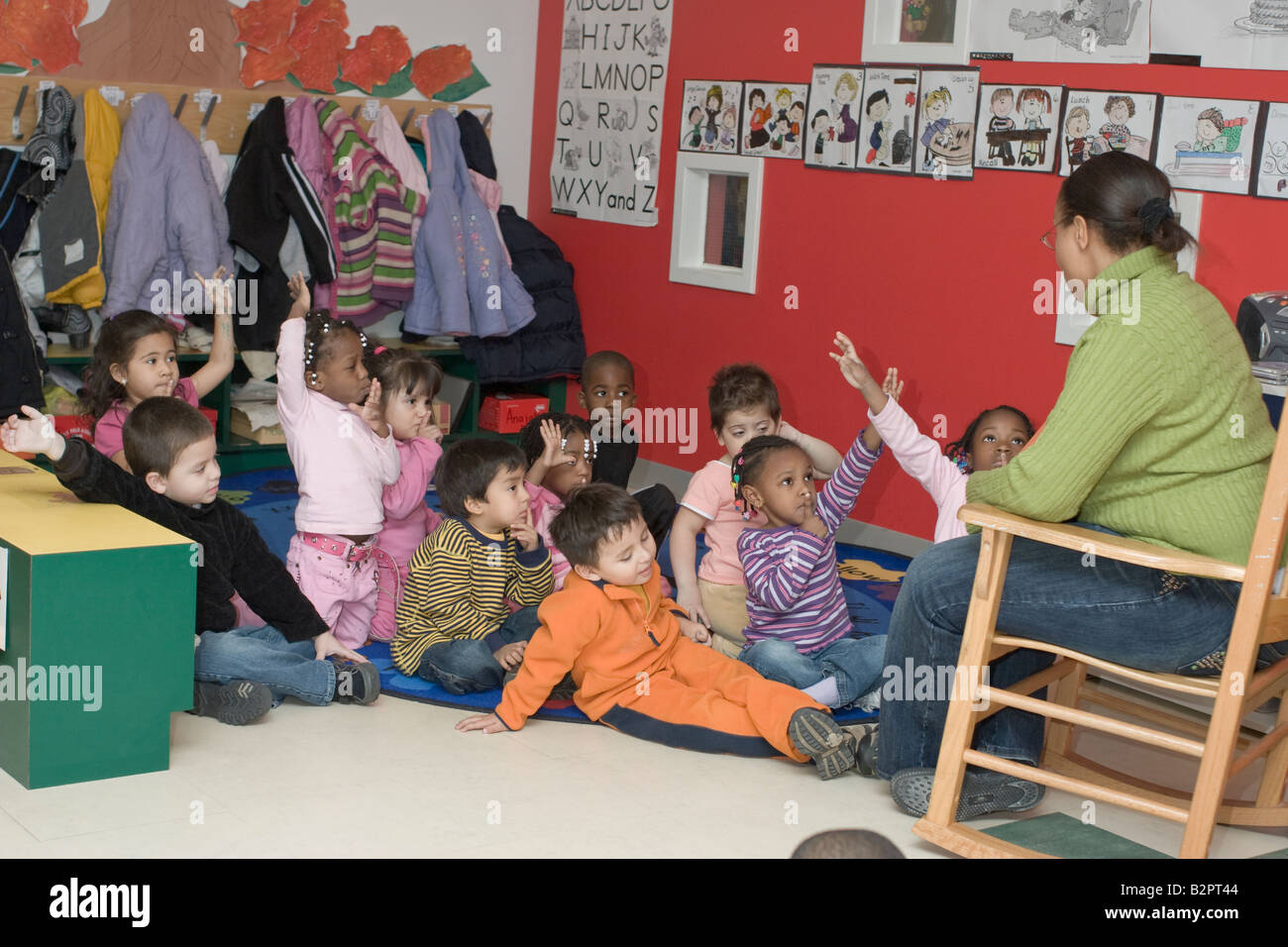 Preschool teacher talking to her students Stock Photo - Alamy