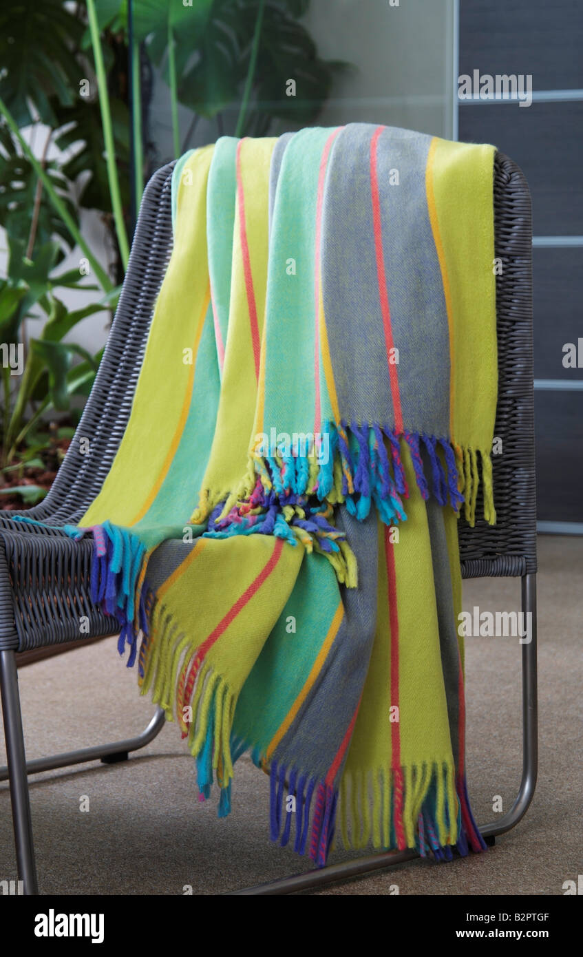 Colourful throw draped over a chair Stock Photo Alamy