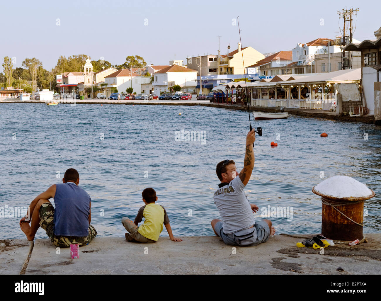 Fishing off the quay in Argostoli Kefalonia Greece Stock Photo