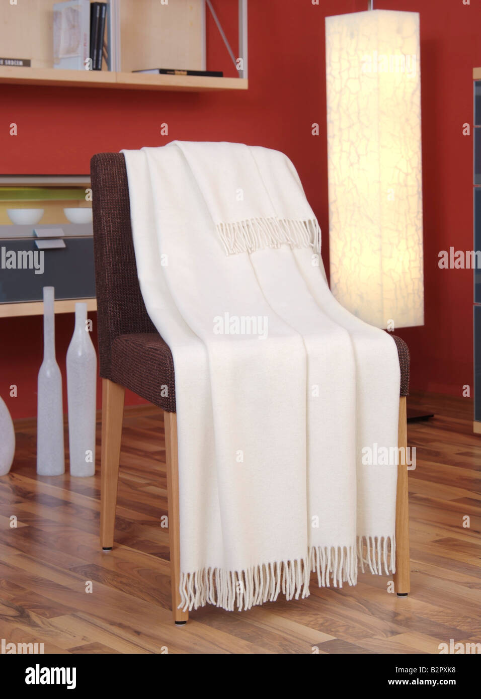 White blanket draped over a chair Stock Photo