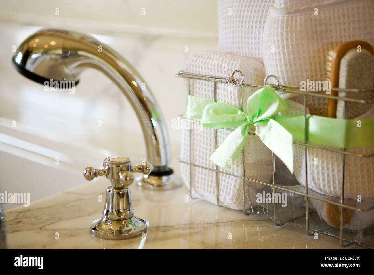 Basket of bath accessories next to tub Stock Photo Alamy