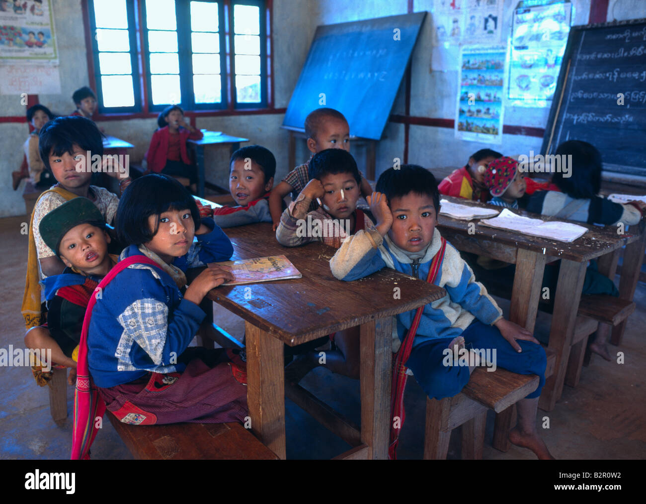 Myanmar Burma Shan State Kalaw District Village of Myindaik young schoolchidren sitting on classroom bench Stock Photo