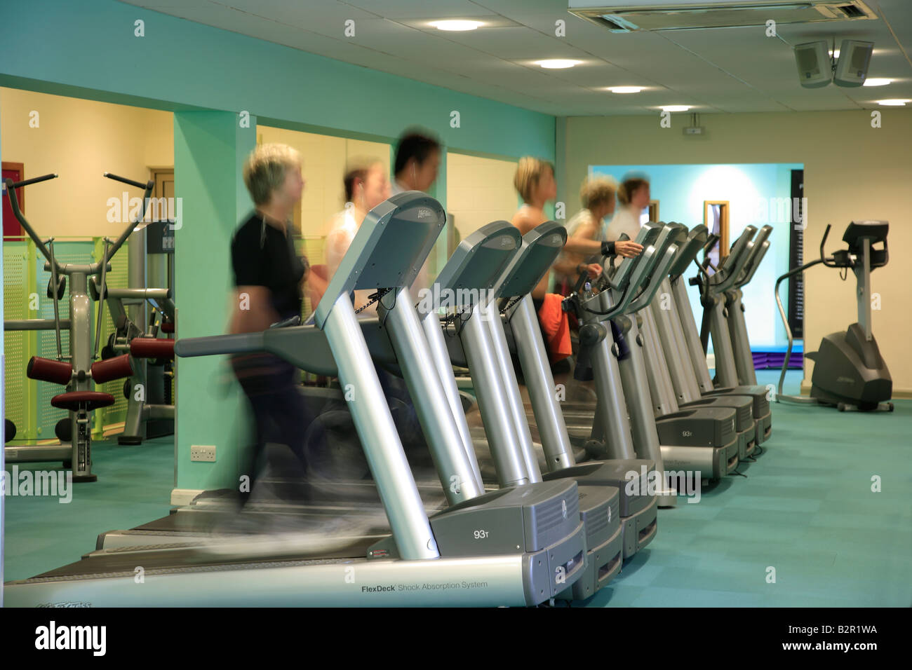 People at the gym on running machines blurred for speed power effects in a Generic Health Spa Gym Stock Photo Alamy