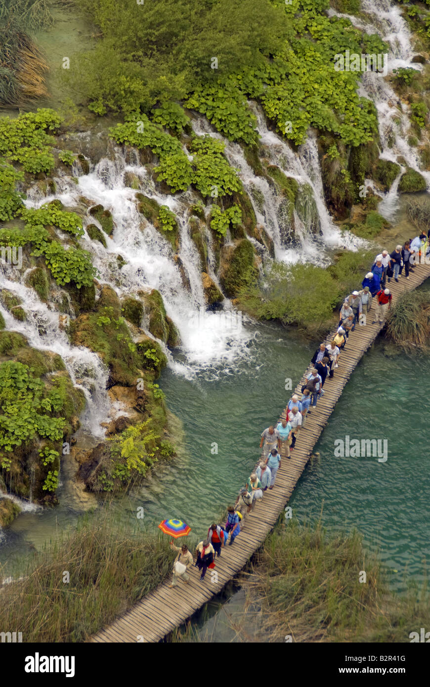 Plitvice Lakes National Park waterfalls between lakes with visitors on boardwalk Stock Photo