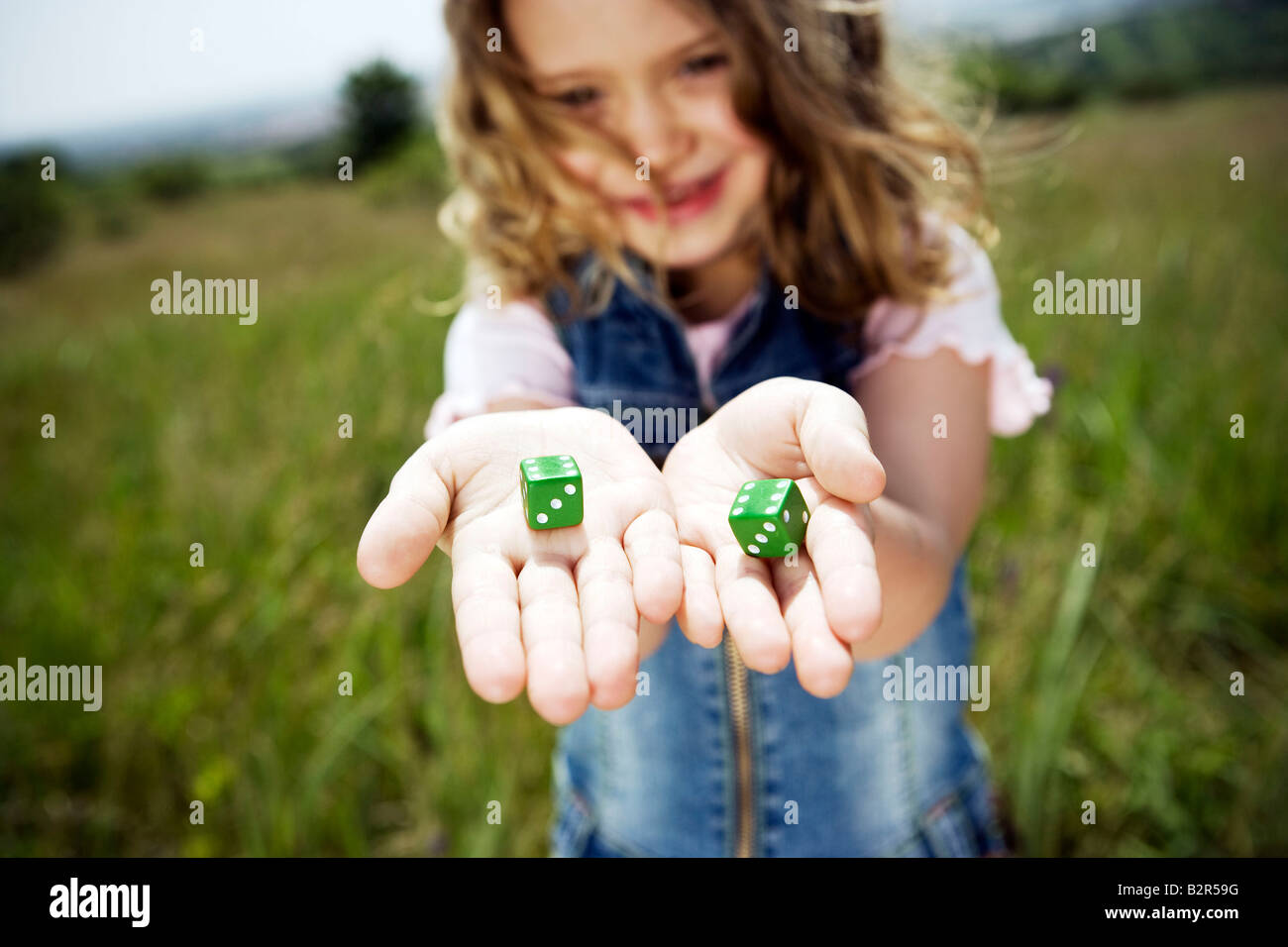 Girl holding dice Stock Photo Alamy