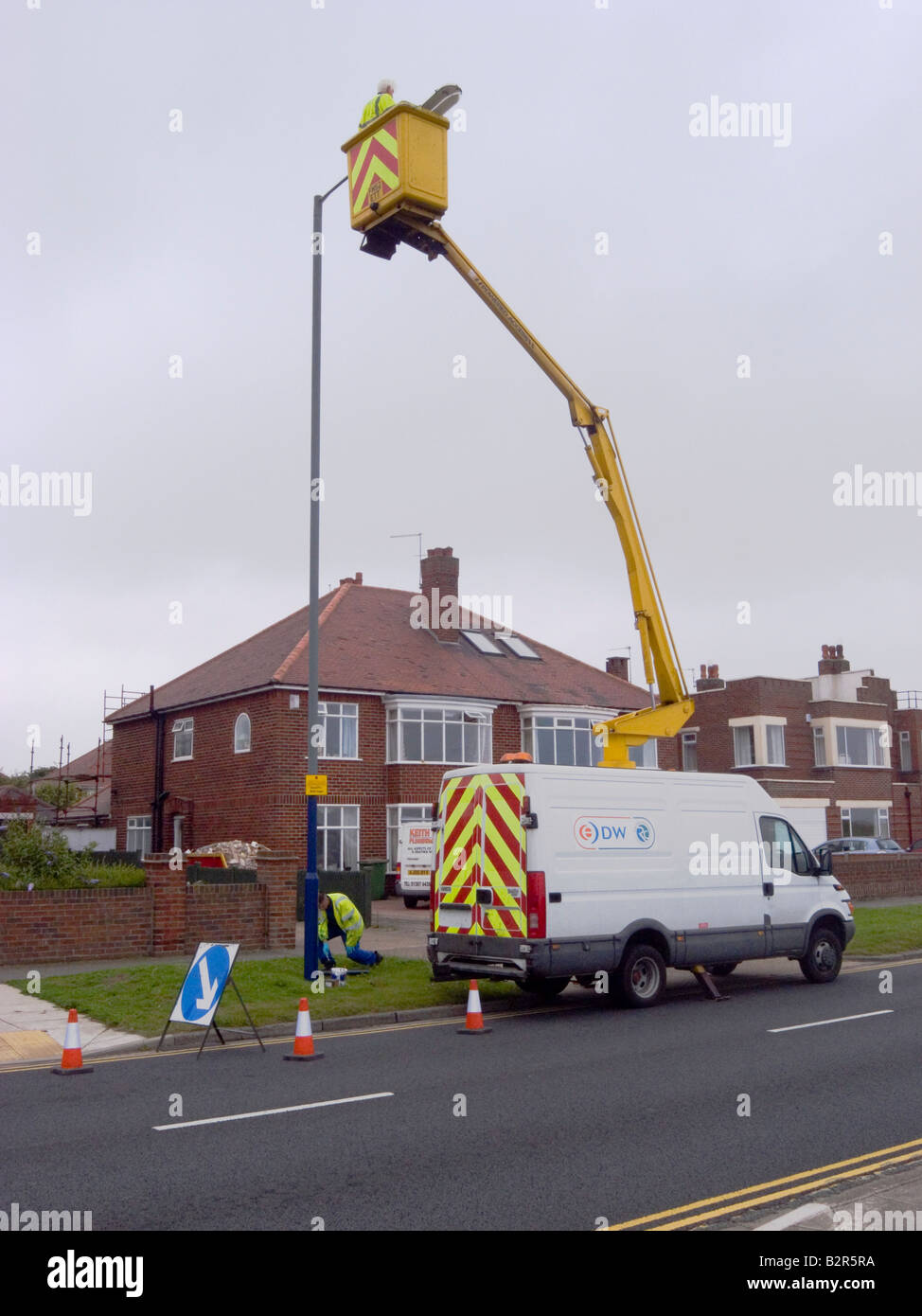 Contractors using a van mounted hydraulic hoist to carry out