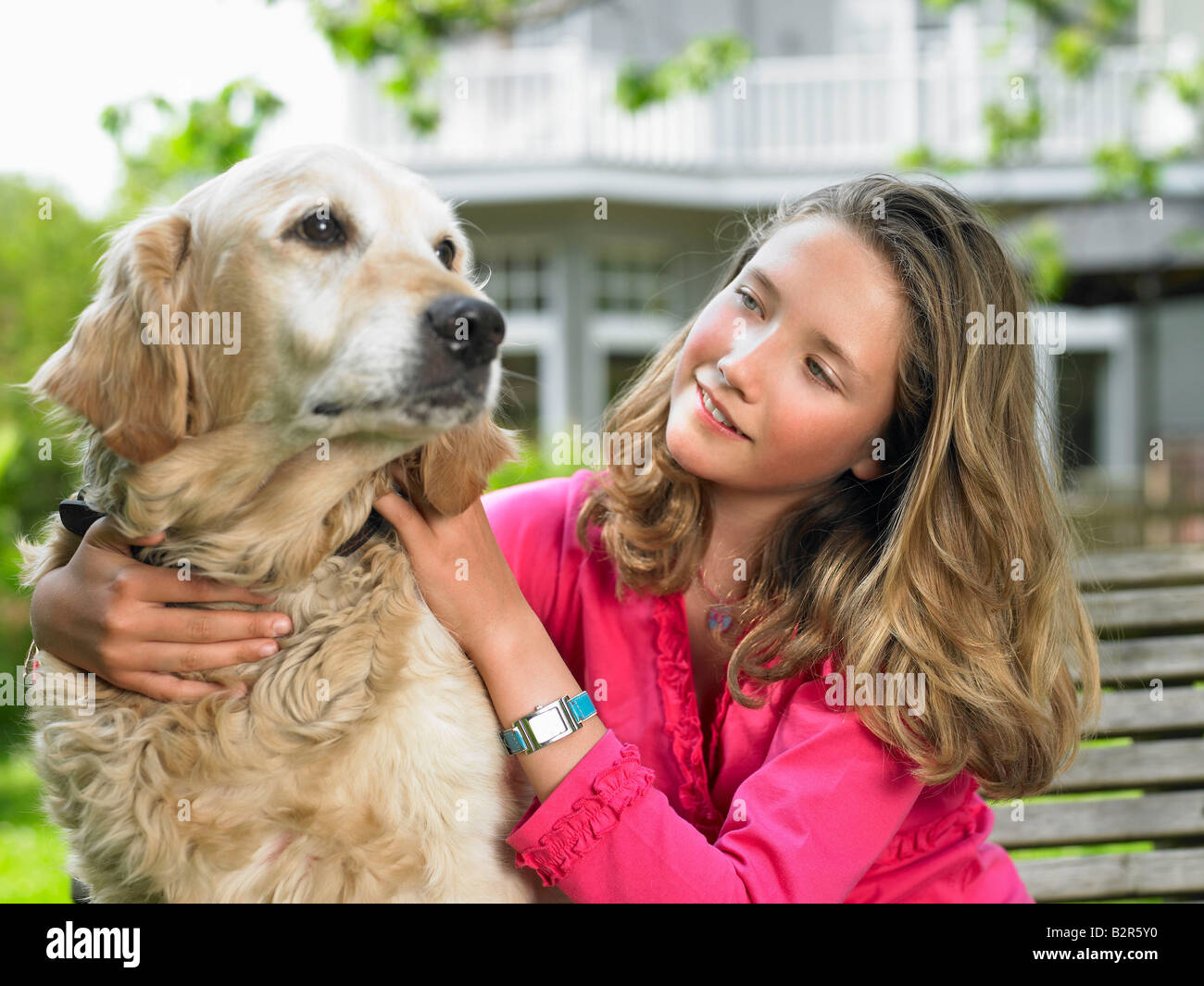 Girl with dog in the garden Stock Photo - Alamy