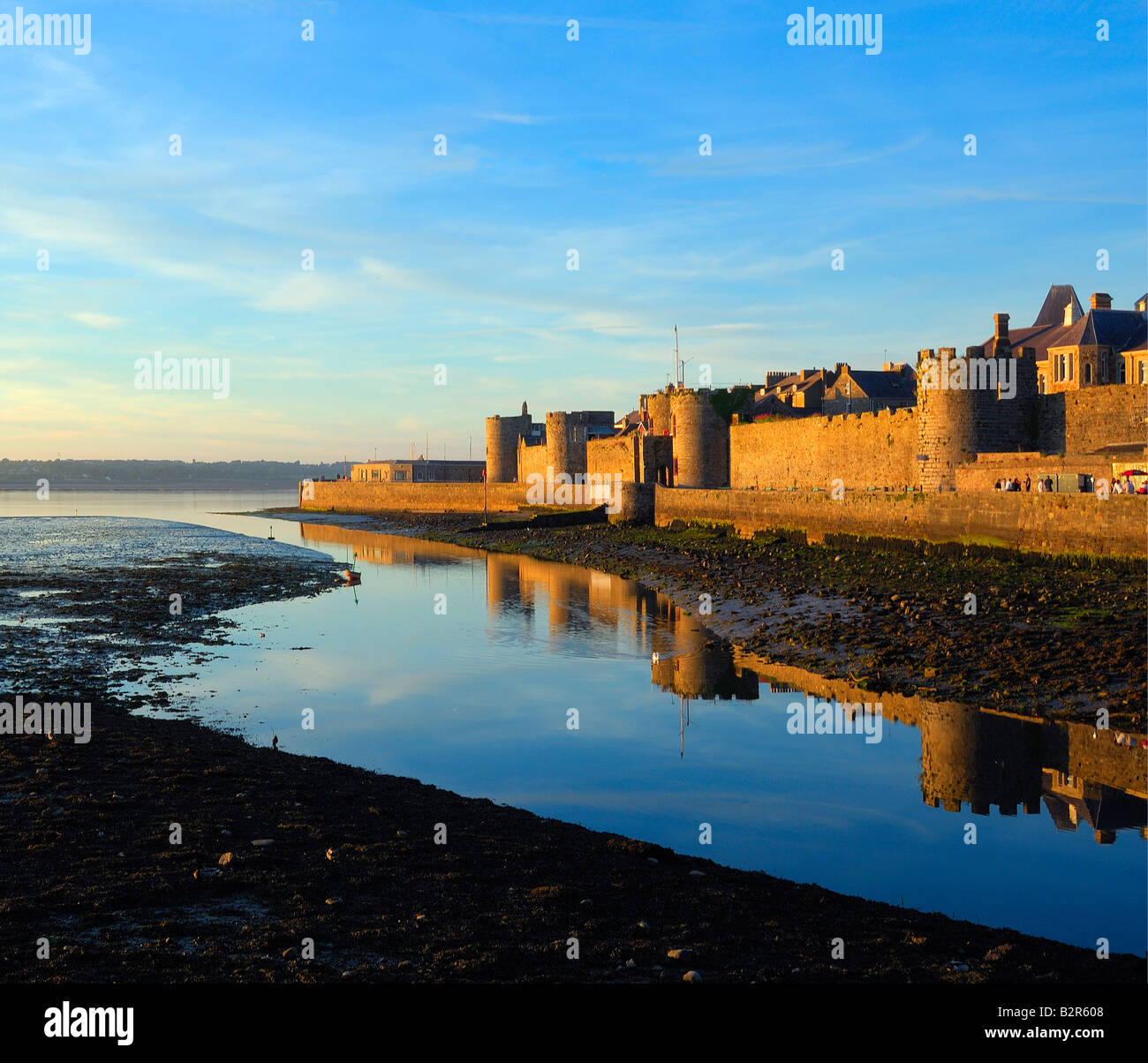 The outer walls of Caernarfon castle on the coast of North Wales in late evening sunshine Stock Photo