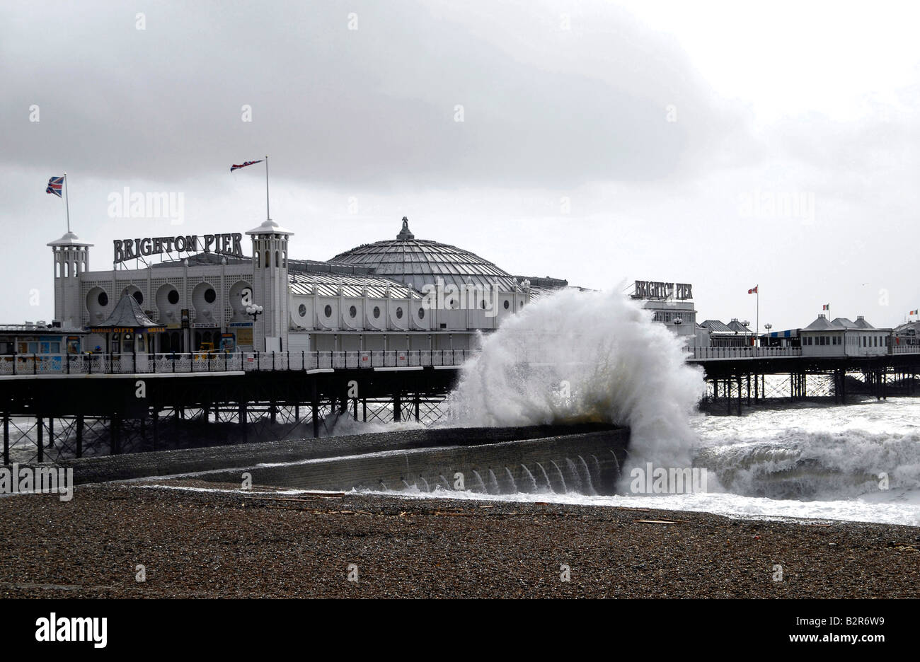 Waves on a jetty by Brighton Pier, formerly Palace Pier, during a winter storm, Brighton, UK Stock Photo