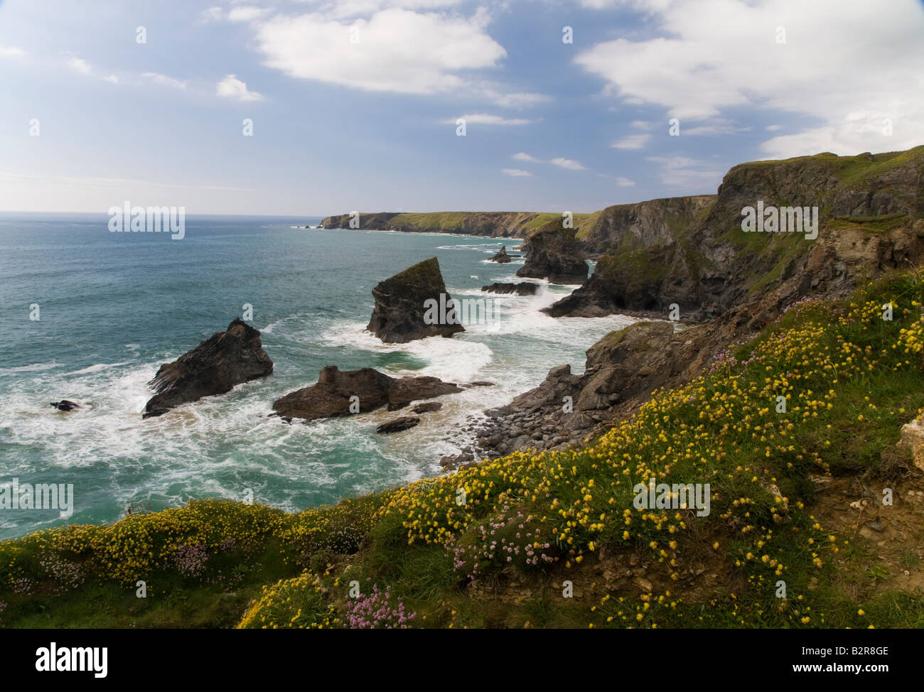Bedruthan Steps with sea in atlantic ocean north cornwall cliffs with blue skies Stock Photo