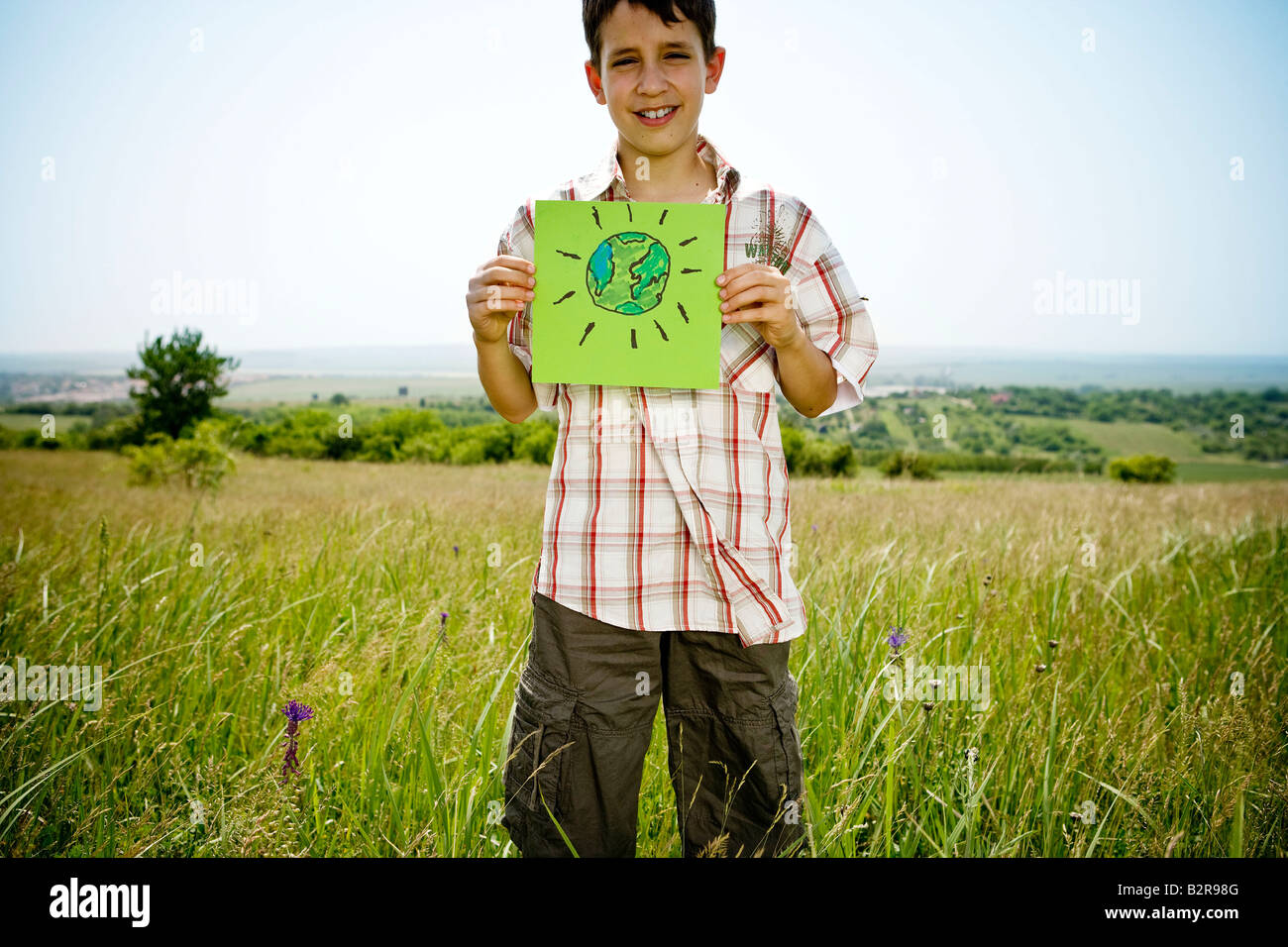 Boy holding picture of earth Stock Photo