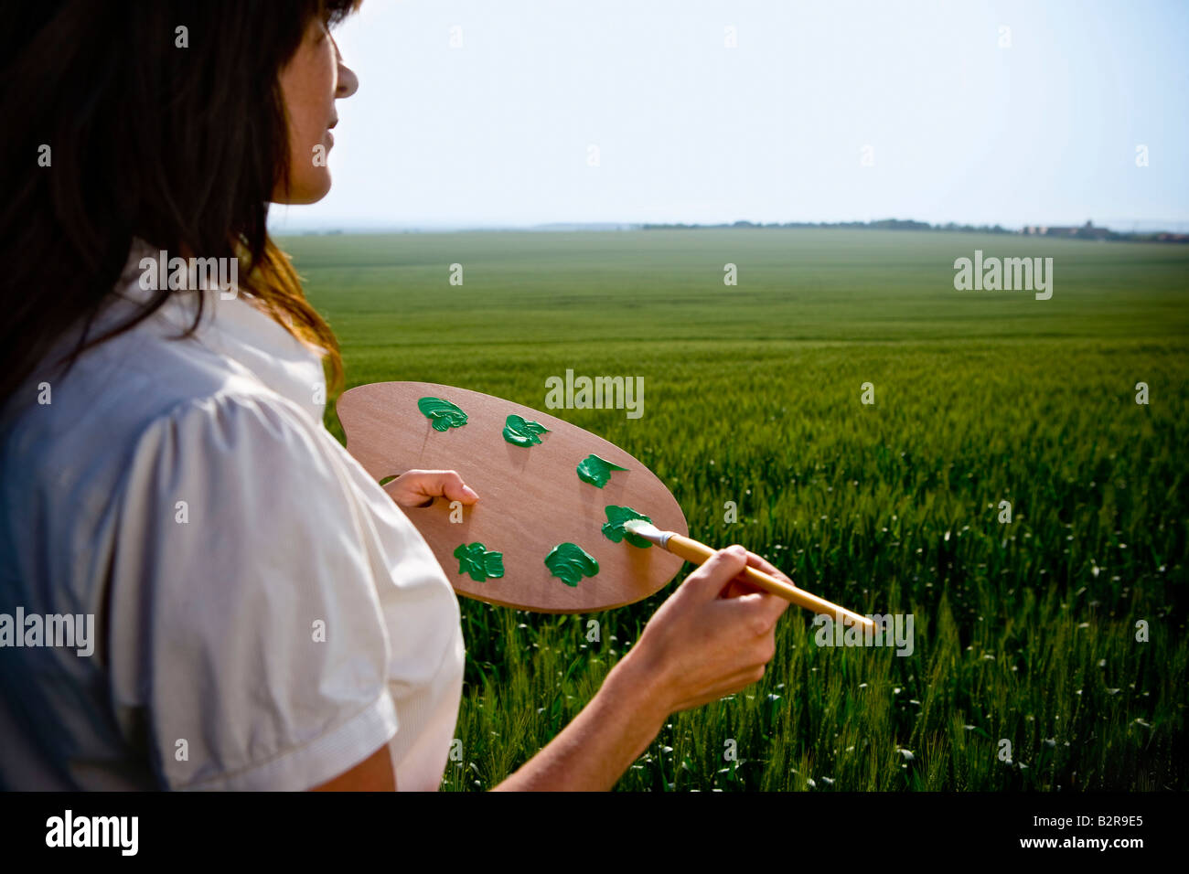 Woman holding painters palette Stock Photo