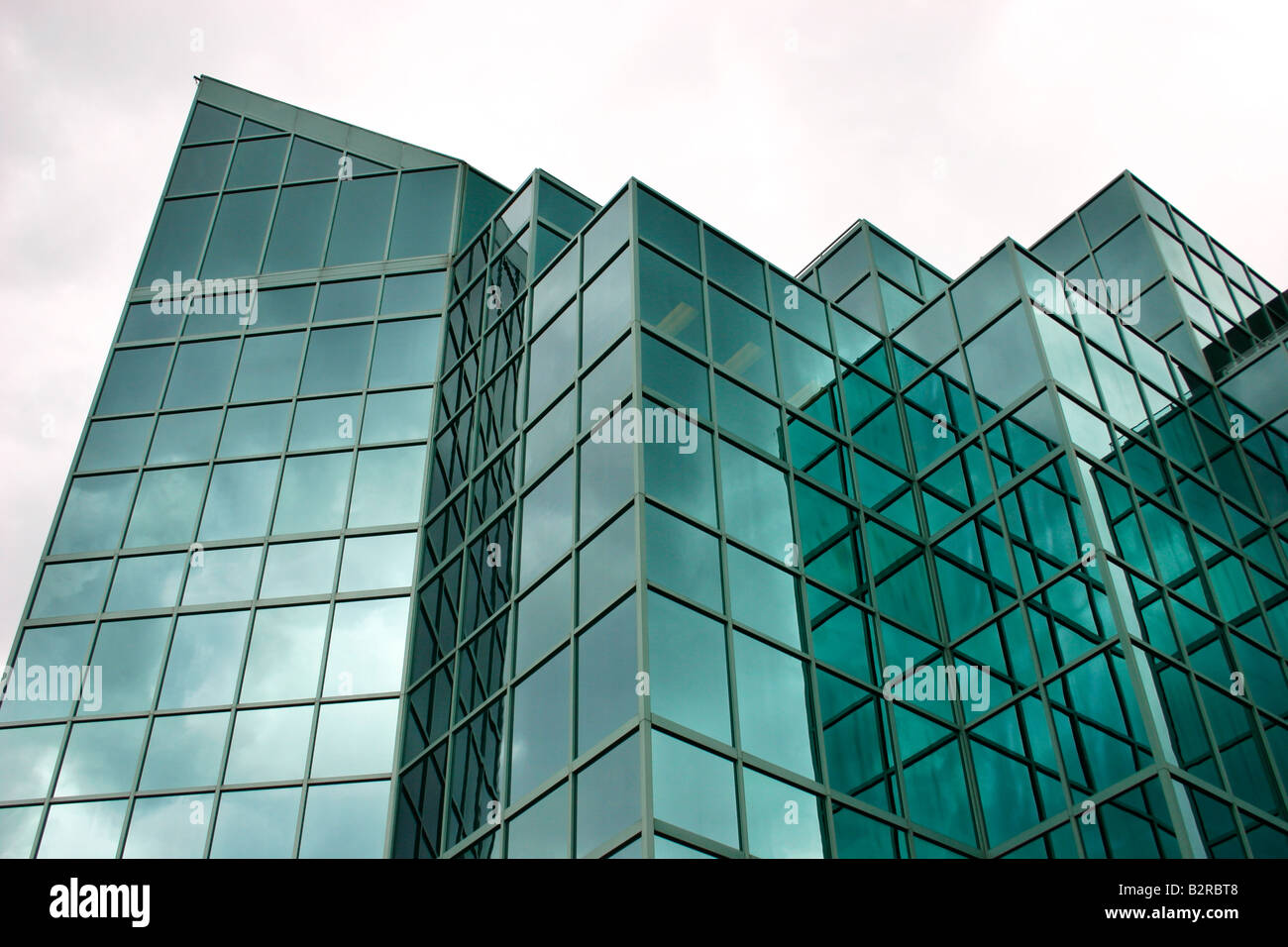 This is a modern glass office building reflecting dark clouds Stock ...