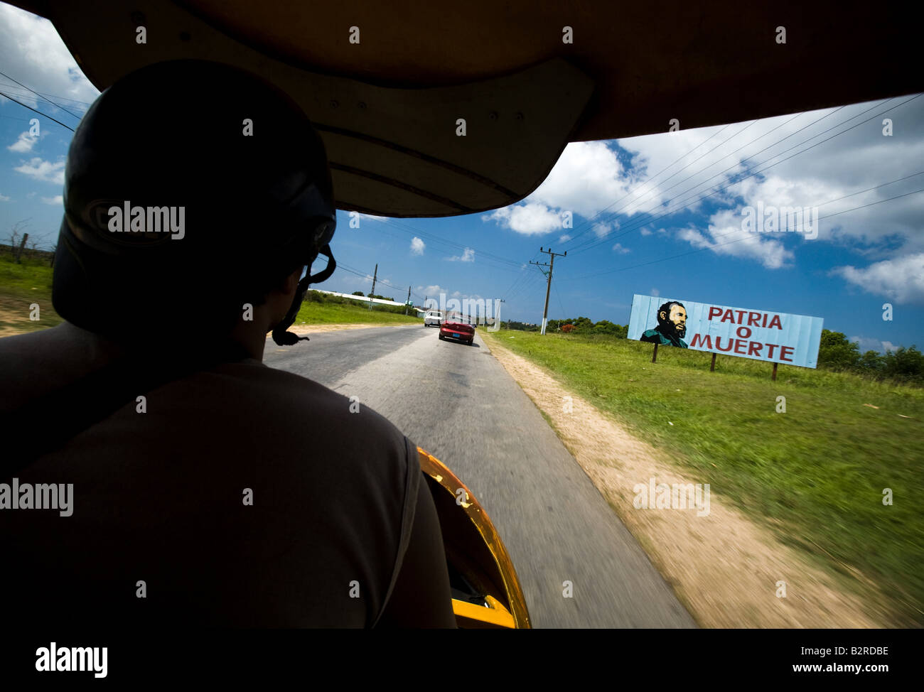 View from inside a coco taxi along the road from Trinidad to Ancon, Cuba Stock Photo