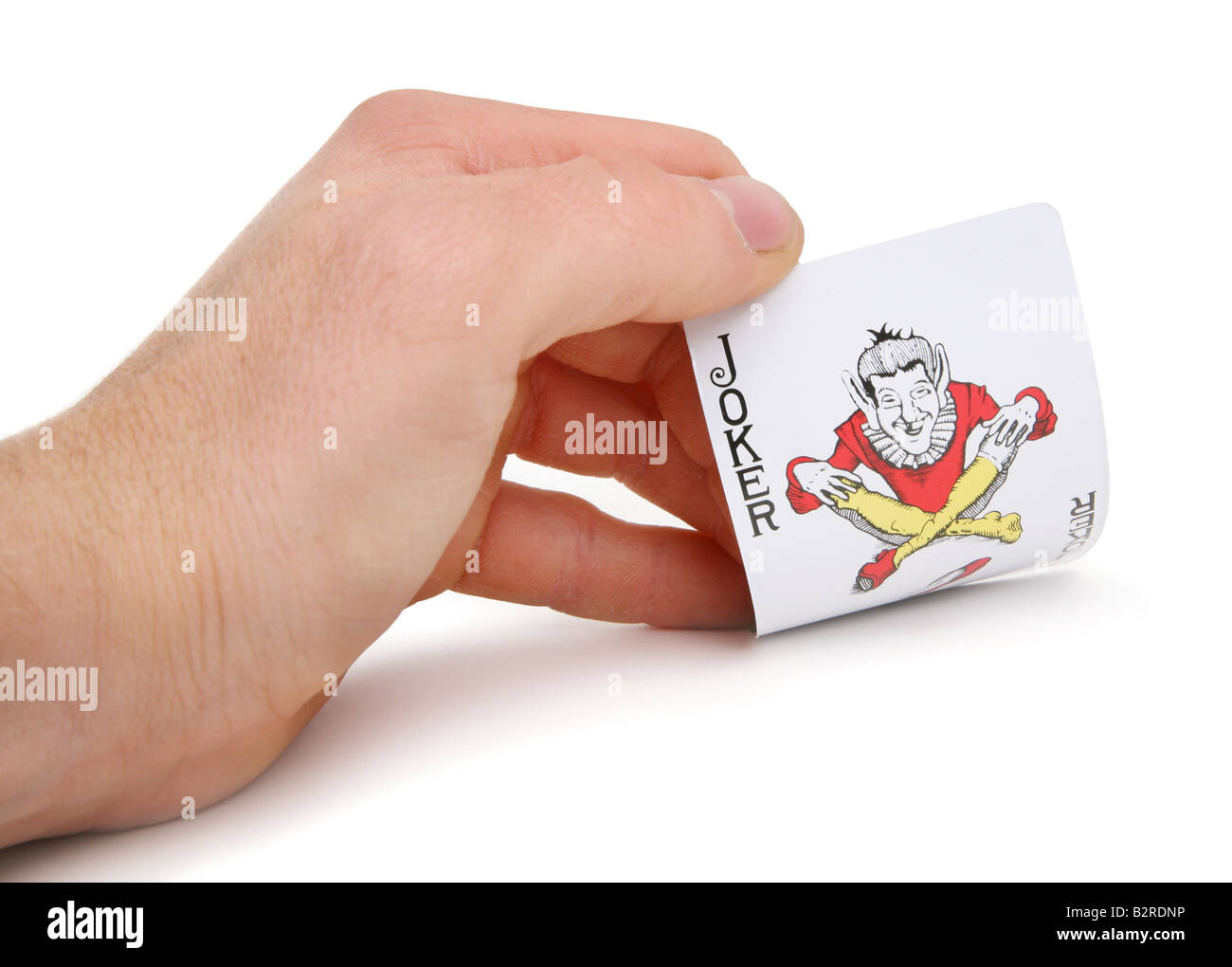 hand turning over a jokers card Stock Photo