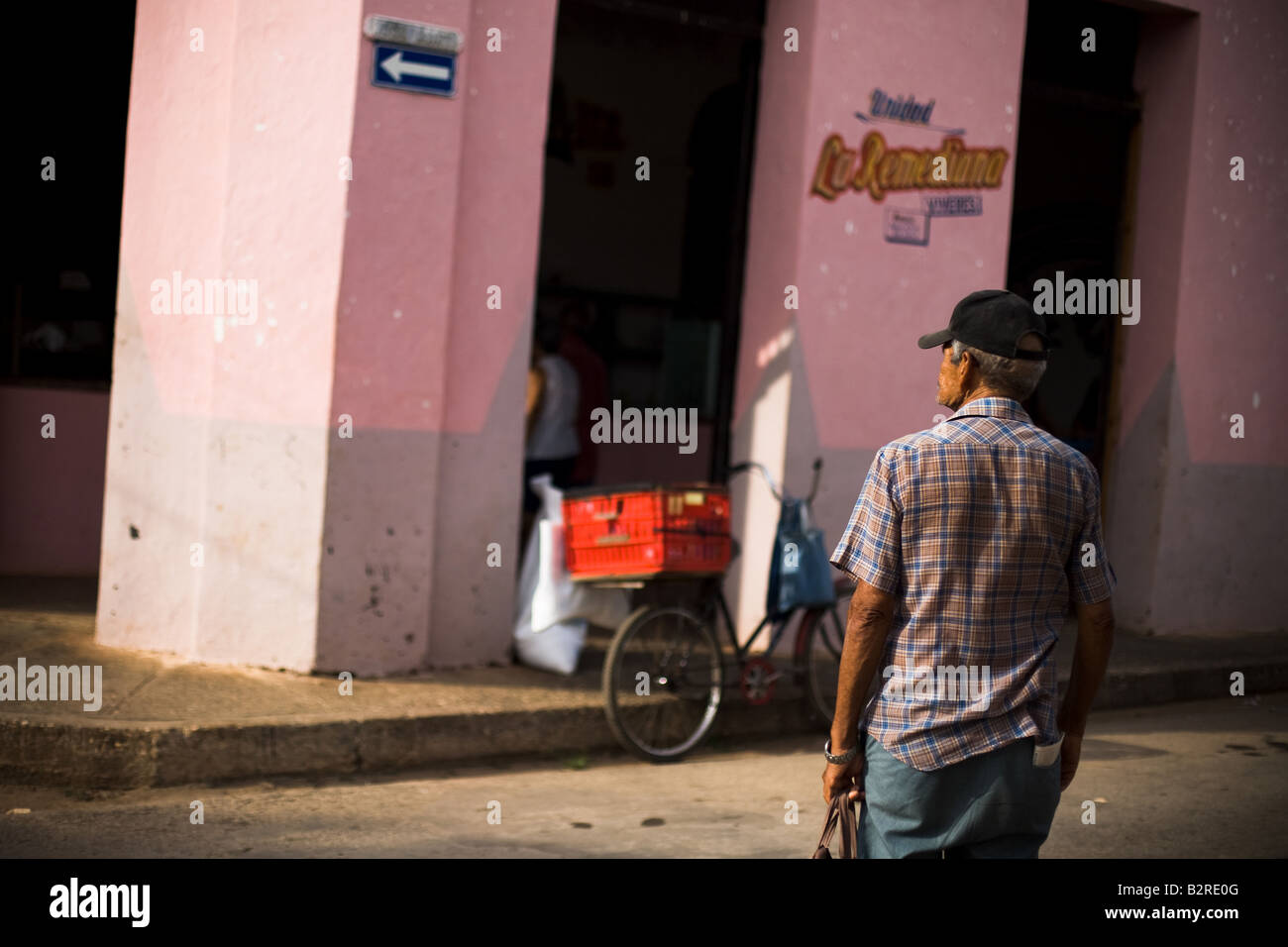 Man waiting to cross a street in Remedios, Cuba Stock Photo