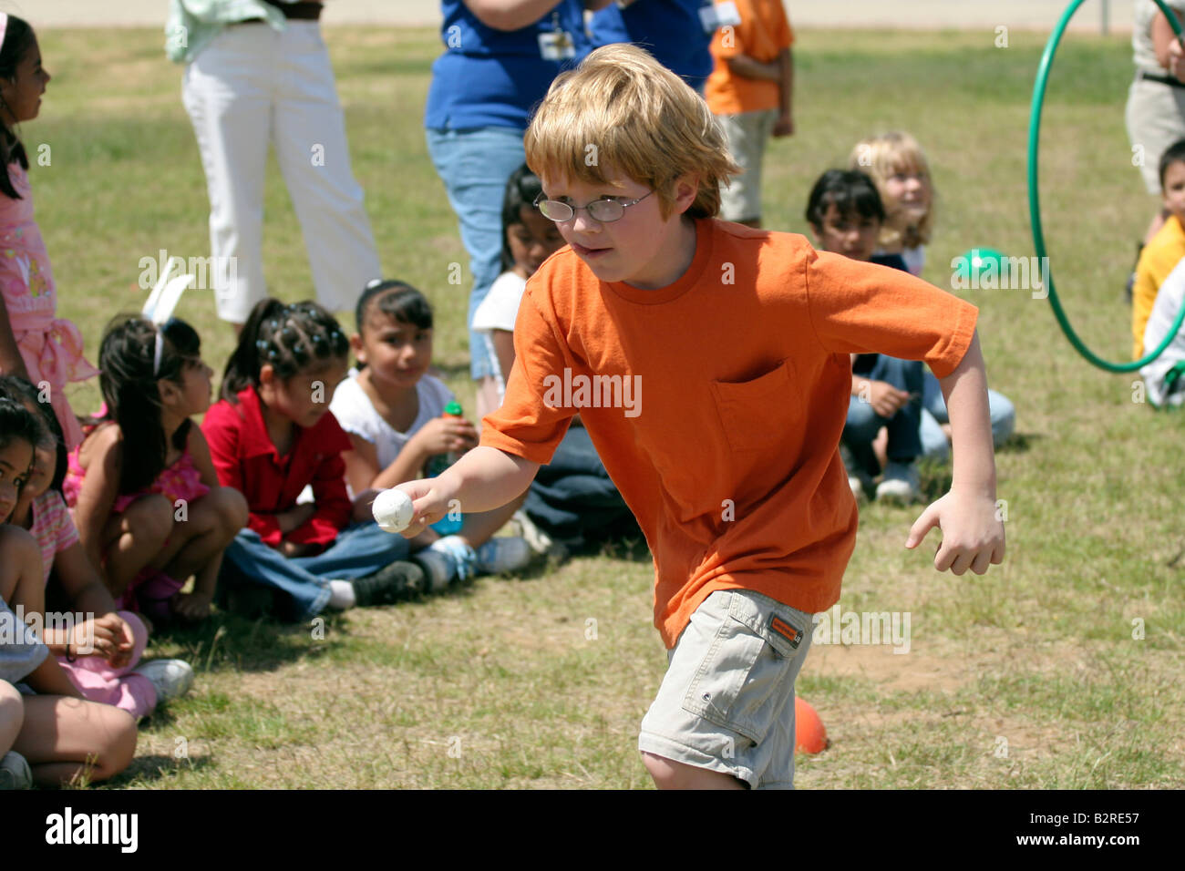 First Grade Student Races During Recess Stock Photo