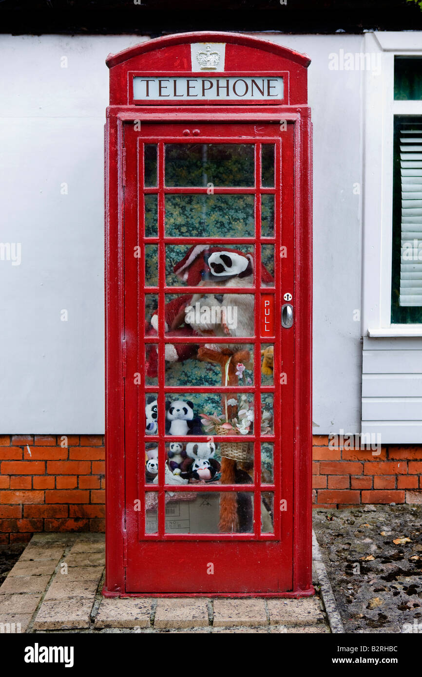 Telephone box full of soft toys in Pilton UK Stock Photo