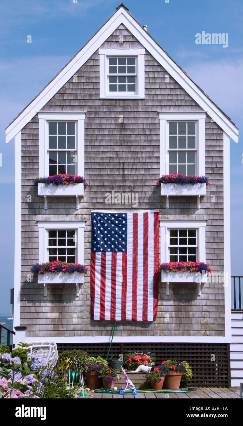 New England Shingled Cape Cod House Flying The American Flag For The Stock Photo Alamy