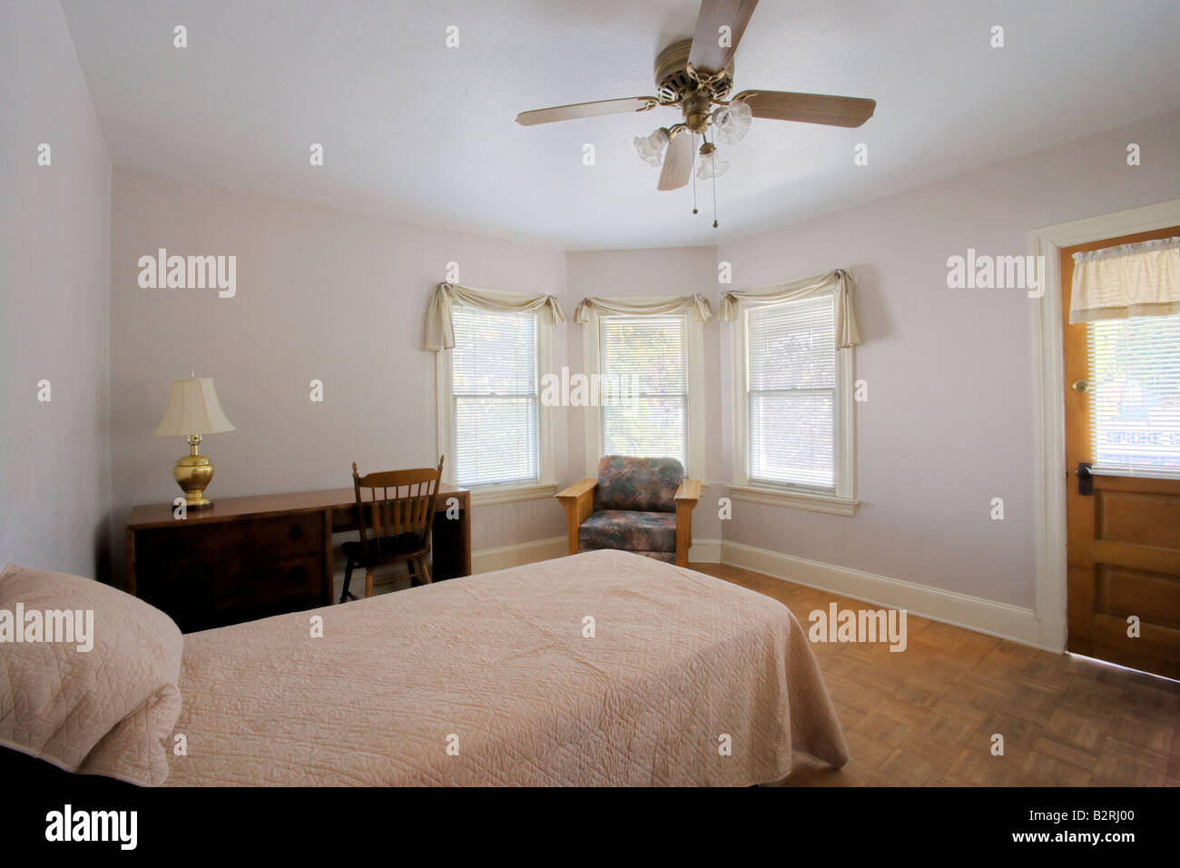 Small bedroom with a desk Stock Photo - Alamy