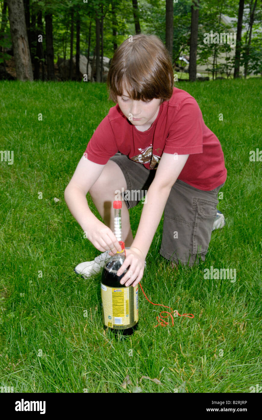 An eleven year old boy setting up a Mentos Fountain Stock Photo