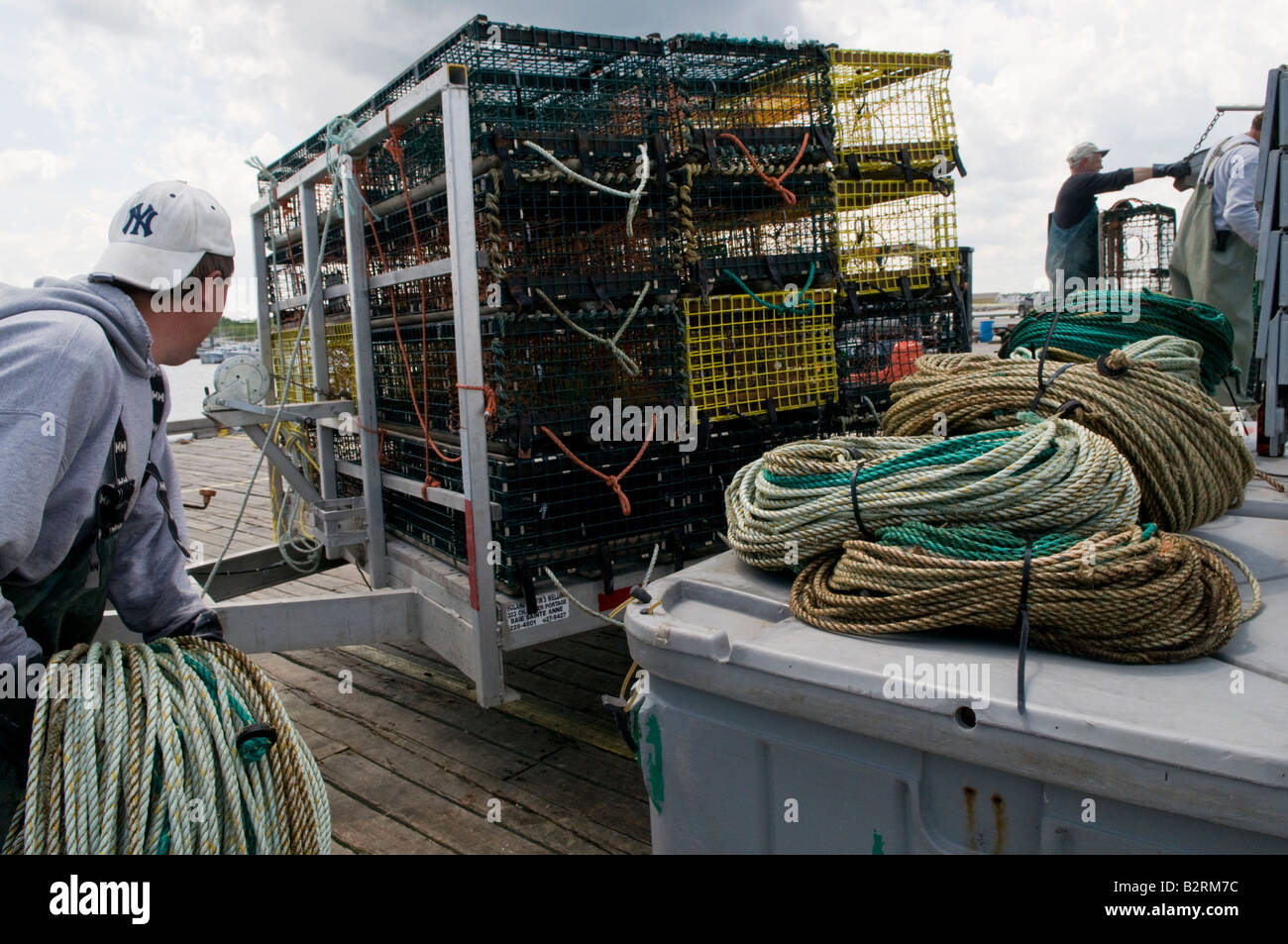 Escuminac Wharf with fishermen unloading lobster traps in New Brunswick Stock Photo