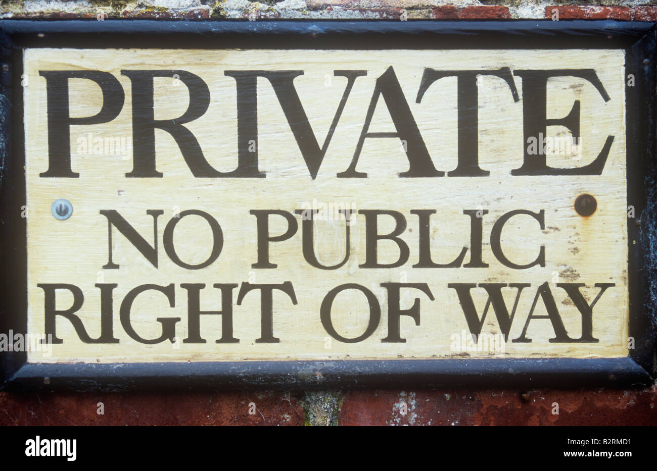 Old-fashioned framed painted notice on brick wall or pillar stating Private No public right of way Stock Photo