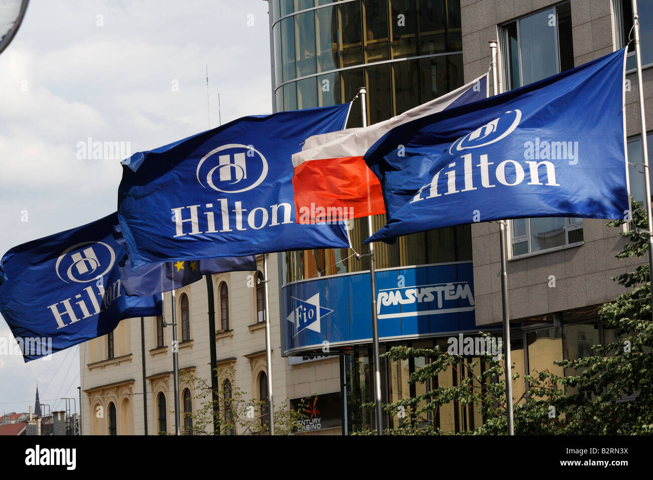 Flags of Hilton hotel, Czech Republic and European Union flying over V. Celnici street in Prague Stock Photo