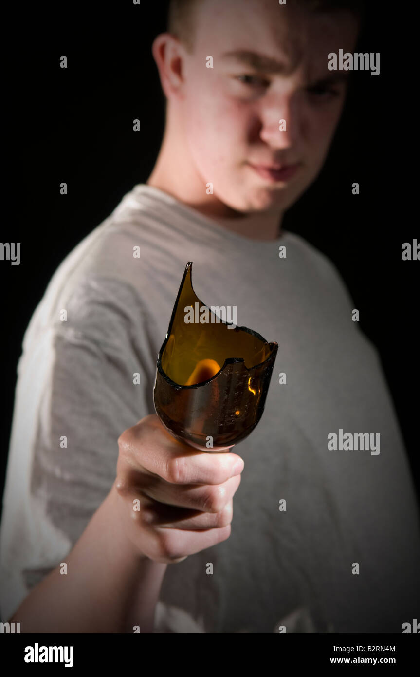 Youth in t-shirt threatening with broken bottle Stock Photo