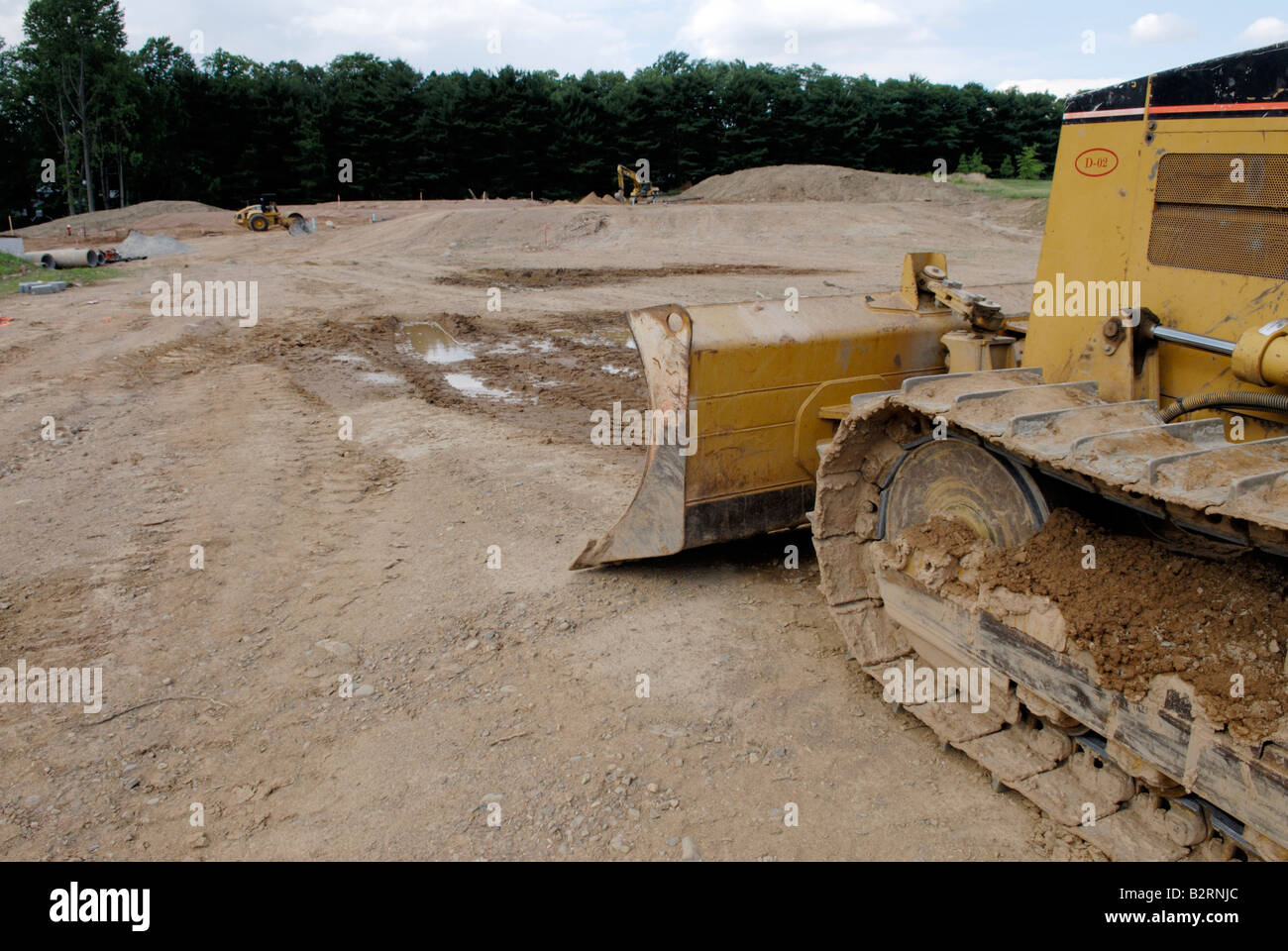 Bulldozer at clearing for a new housing development Stock Photo