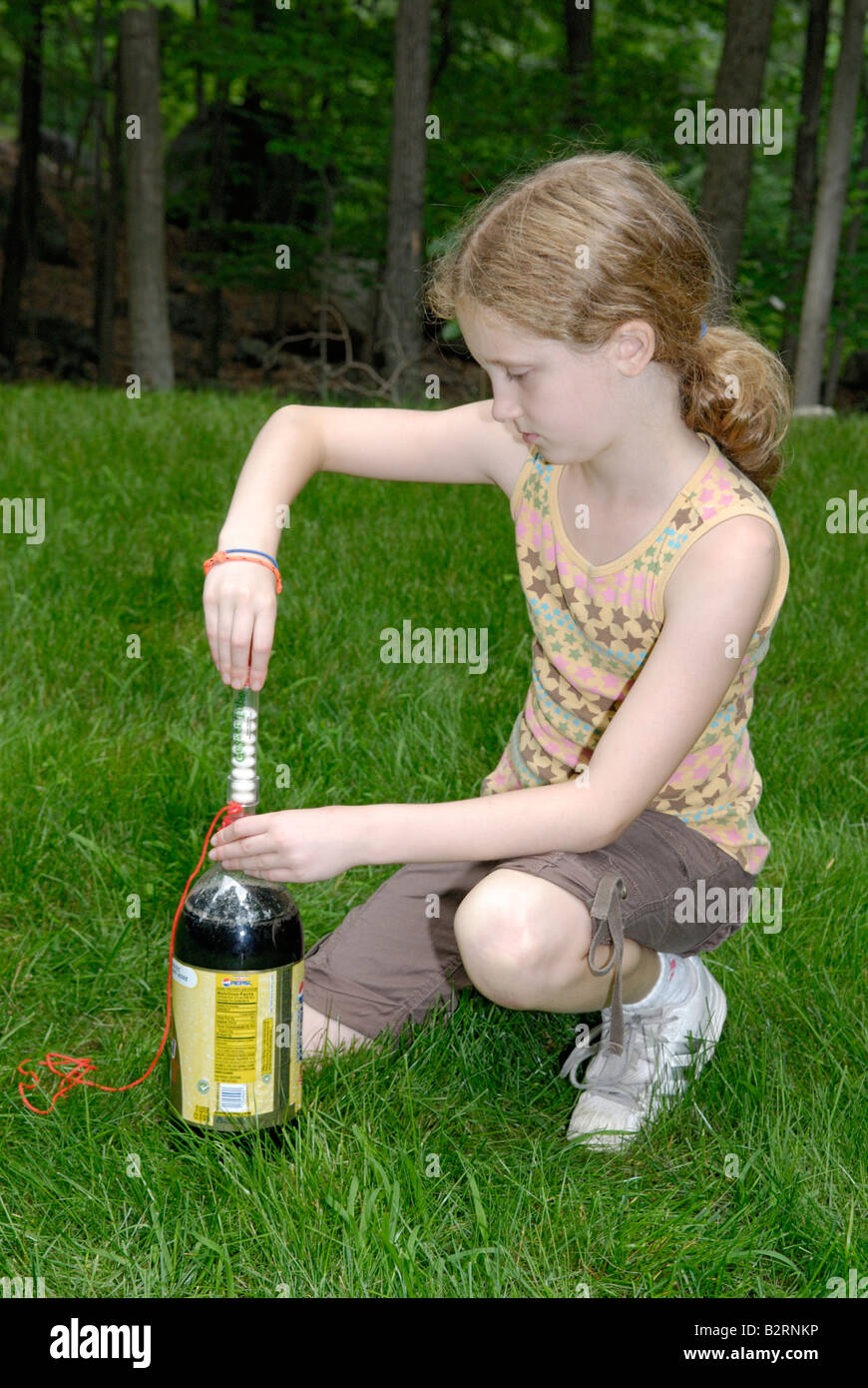An nine year old girl setting up a Mentos Fountain demonstration Stock Photo