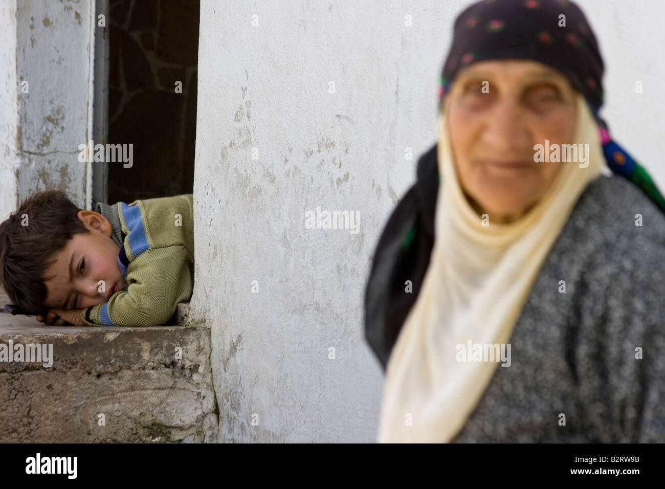 Elderly Syrian Woman and Young Boy in Apamea Syria Stock Photo