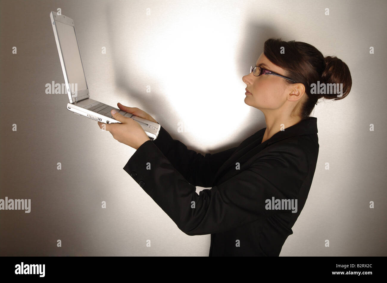 Businesswoman aged 24 holding a laptop Stock Photo