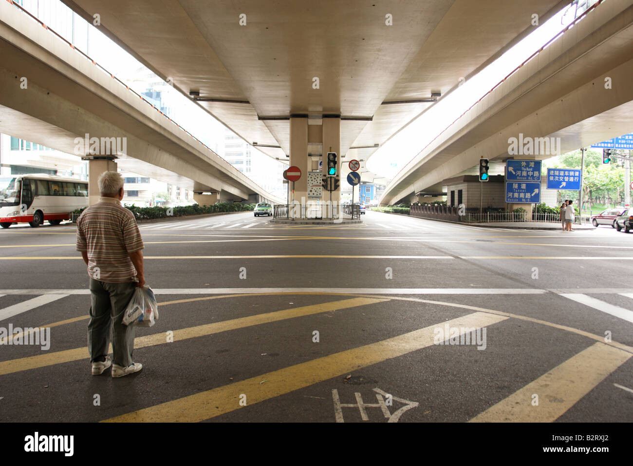 Man waiting under a freeway interchange in Shanghai Shanghai Shi China Asia Stock Photo