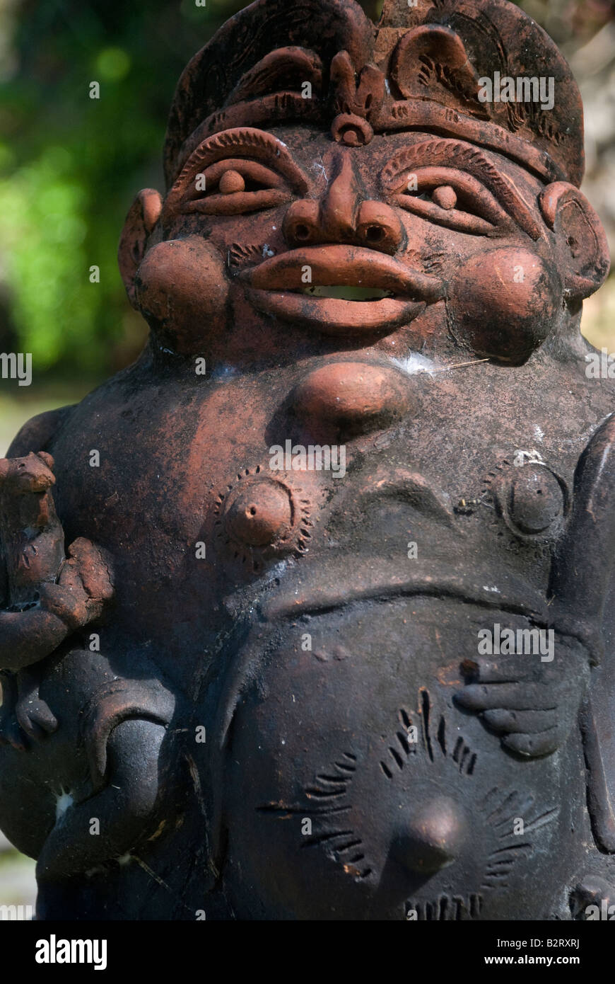 bali indonesia gargoyle sculpture scare scary frighten ward off stone grumpy ugly eyes nose mouth hindu grotesque Stock Photo