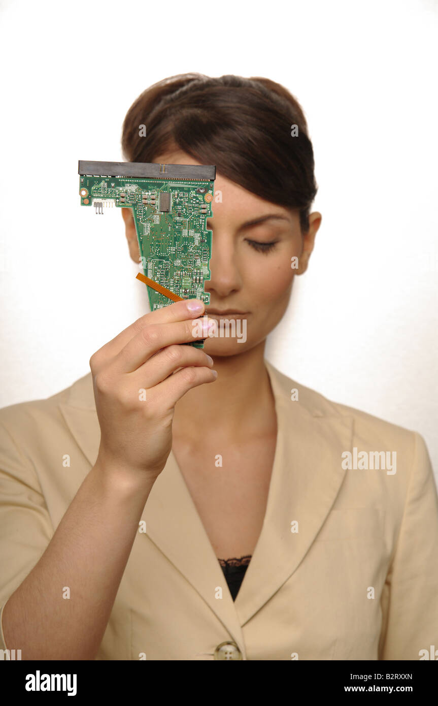 Portrait of a businesswoman aged 24 holding a printed circuit board Stock Photo