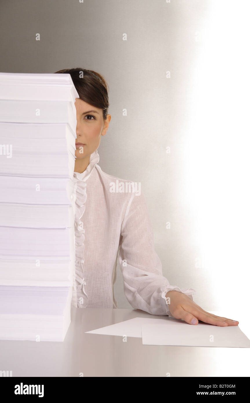 Businesswoman aged 24 taking notes at a silver desktop Stock Photo