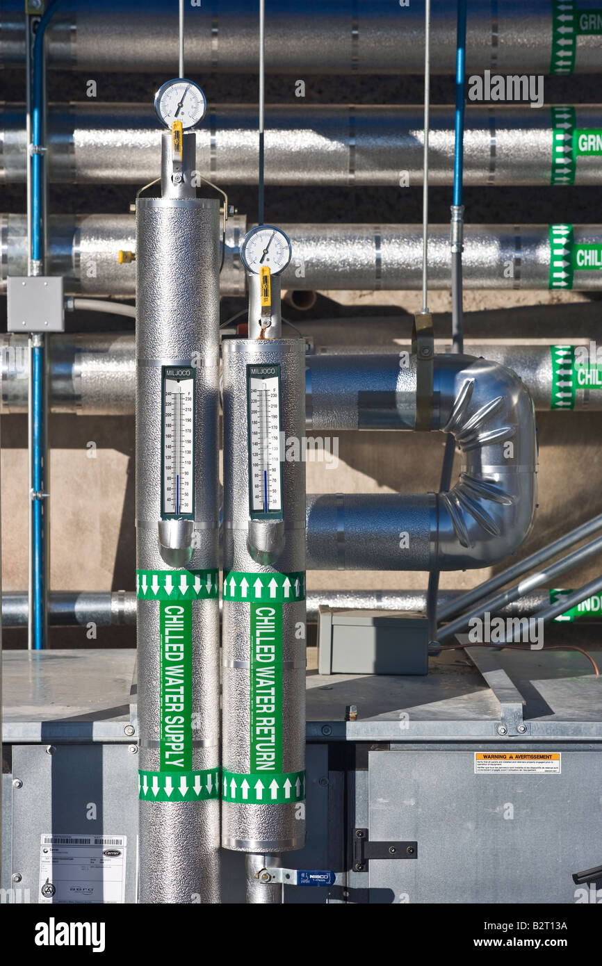 Air conditioning unit pipework, gauges and signage Stock Photo Alamy