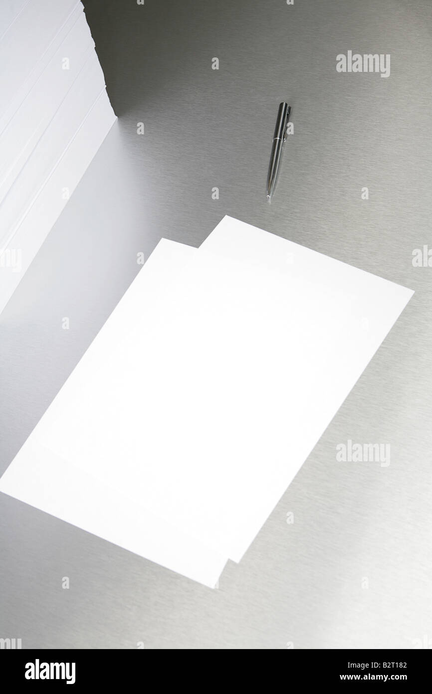 Silver desktop with a pen and sheets of paper Stock Photo