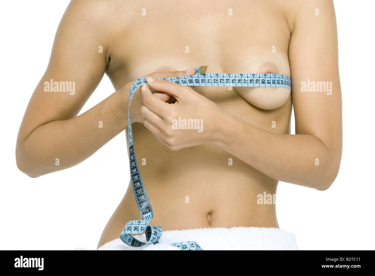 Nude woman wrapping measuring tape around breasts, cropped view Stock Photo  - Alamy