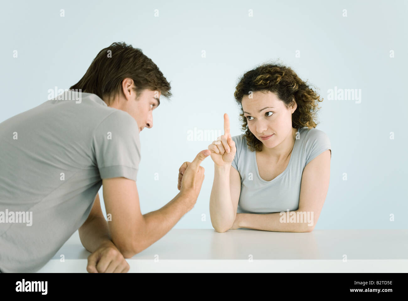 Couple arguing, making gestures, waist up Stock Photo