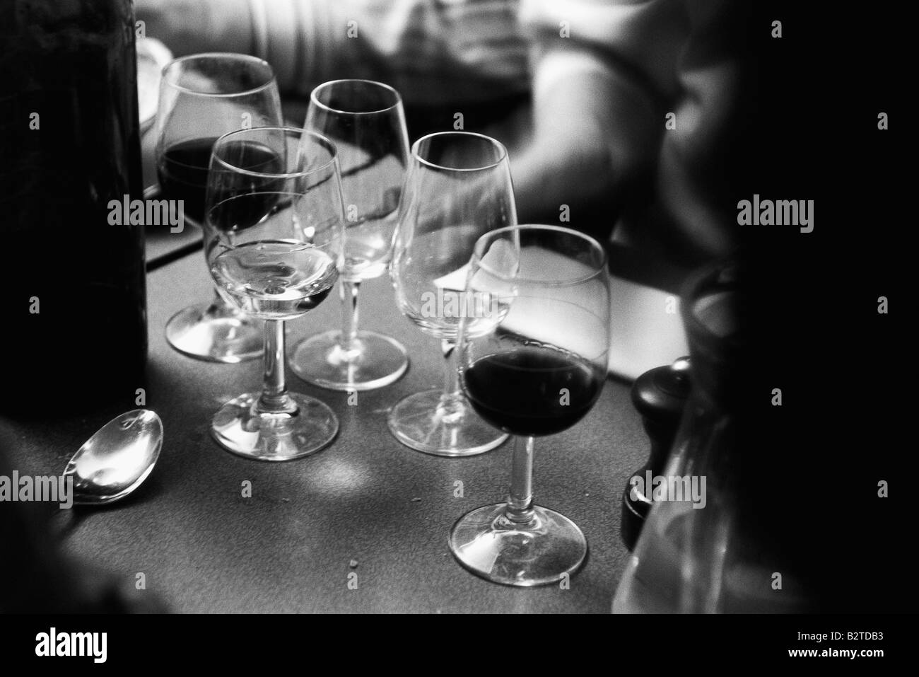 Wine glasses on counter, some empty Stock Photo