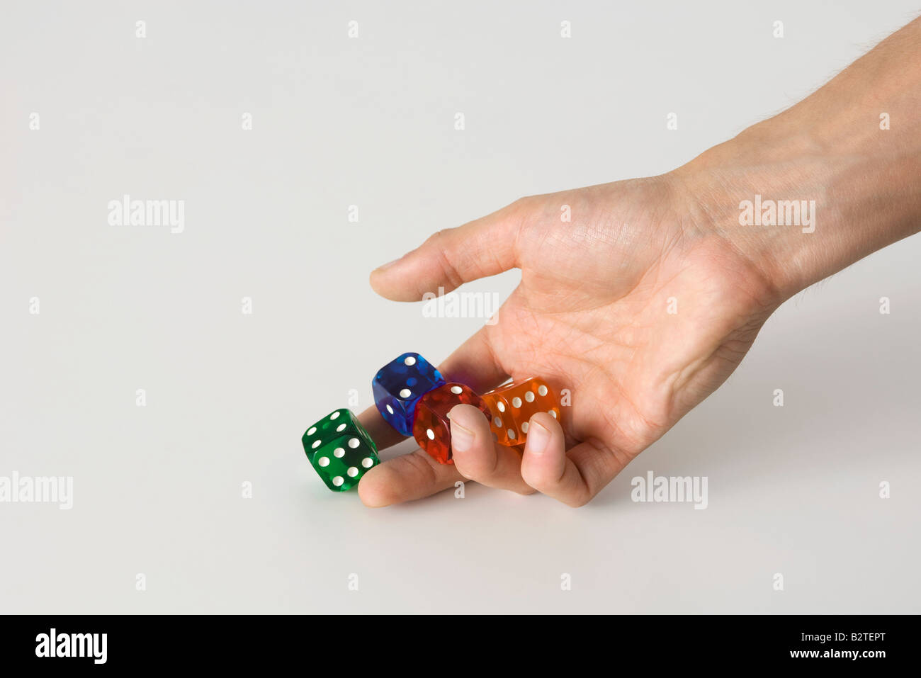 Hand rolling dice Stock Photo
