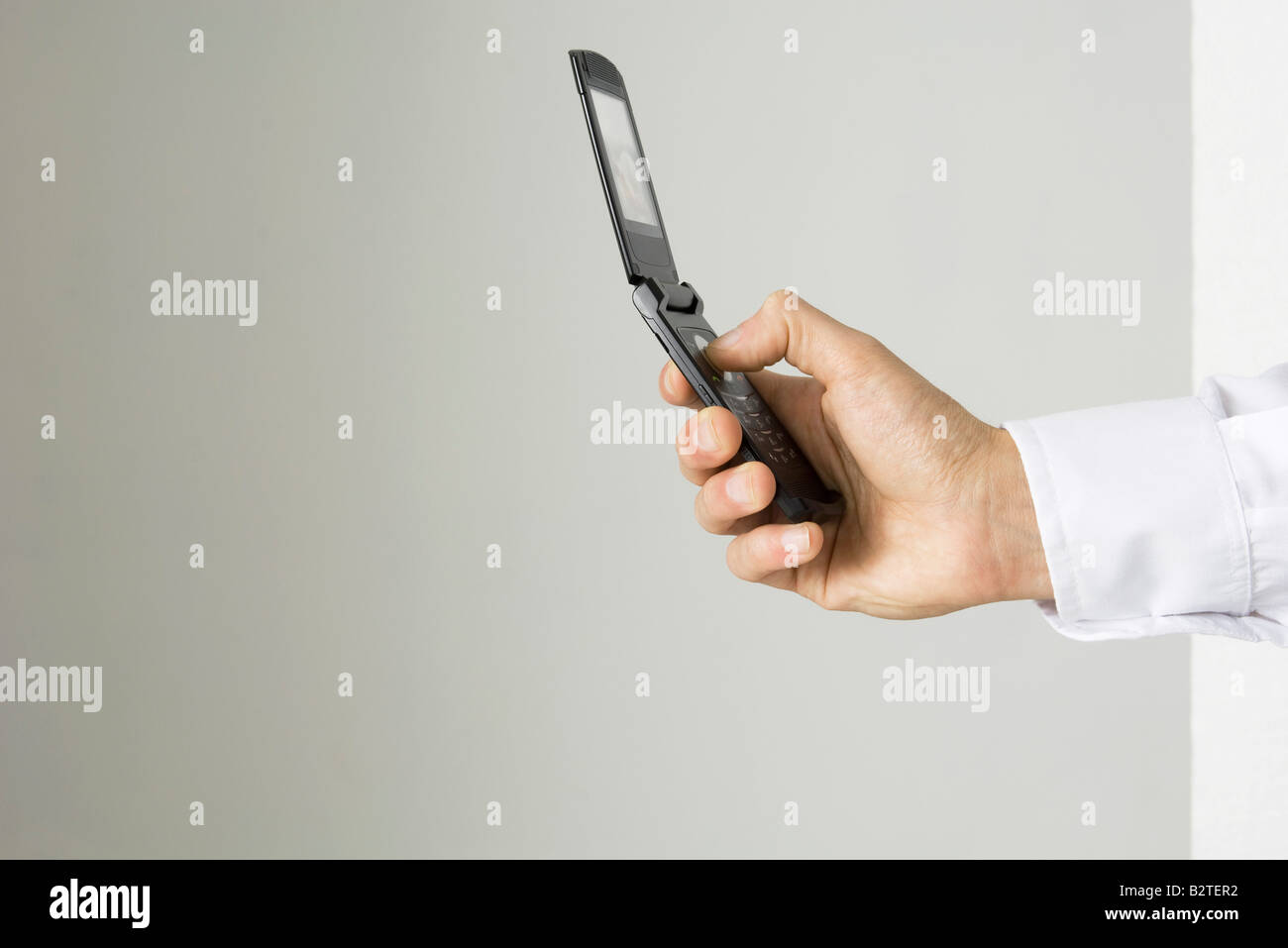 Hand holding cell phone, side view Stock Photo
