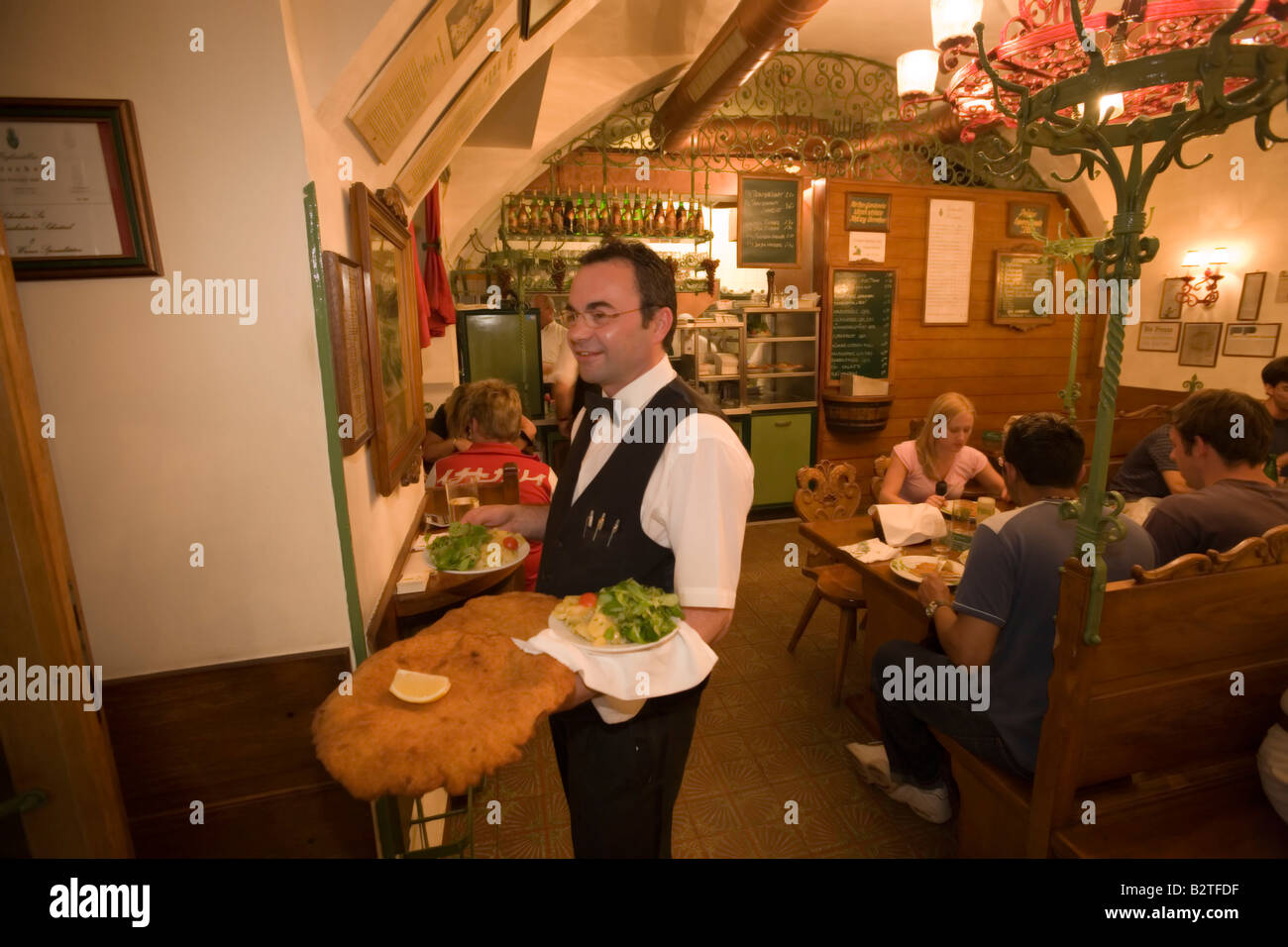 Waiter serving giant Wiener Schnitzel at Restaurant Figlmueller, Vienna,  Austria Stock Photo - Alamy