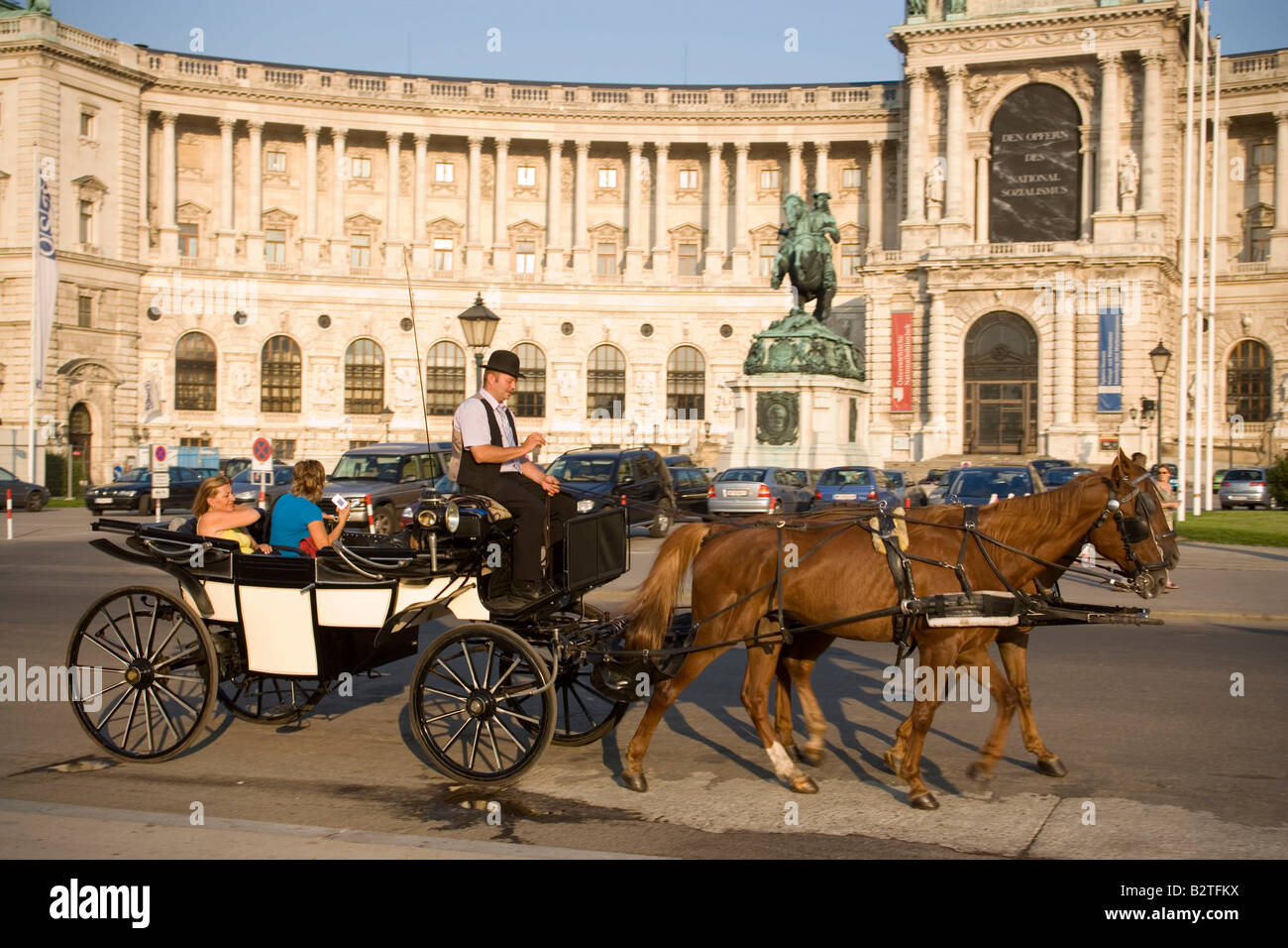 Fiaker passing the Neue Hofburg during a city tour, Vienna, Austria Stock Photo