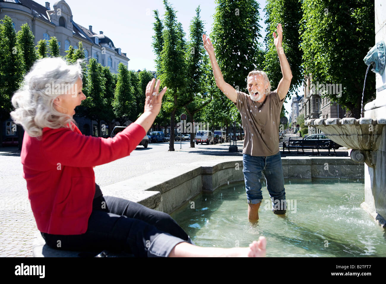 Man throwing water at woman Stock Photo Alamy
