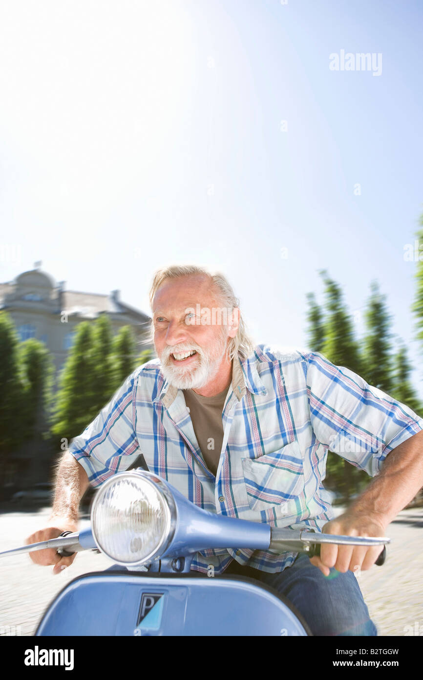 Man on scooter Stock Photo