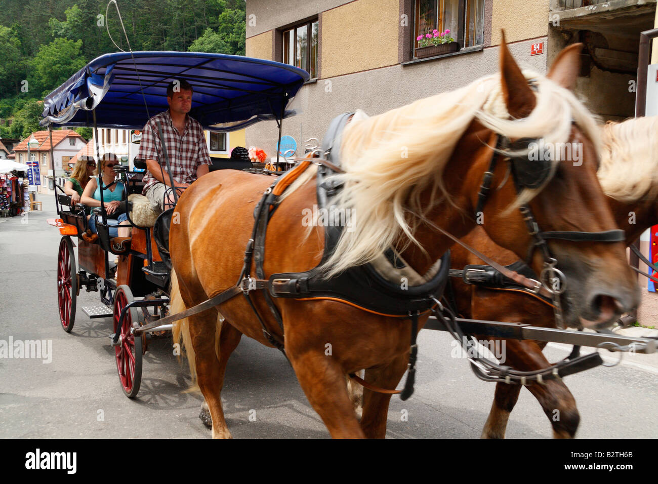 Horse carriage transporting tourists from the traiin station to the Karlstein castle near Prague. Stock Photo