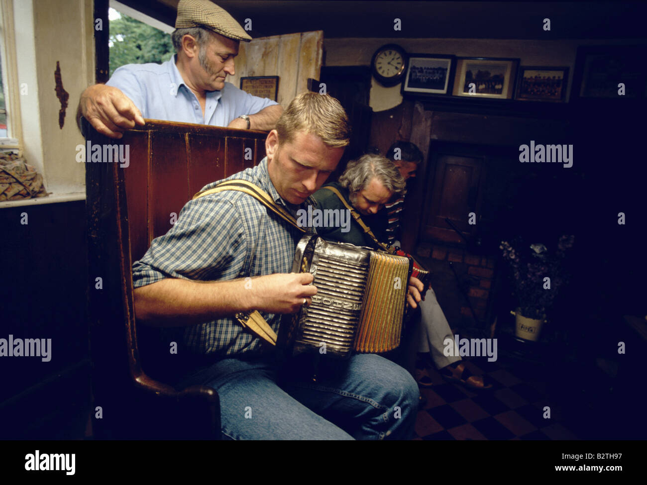 Two men playing music in the Kings Head Pub, Laxfield, Suffolk, England Stock Photo
